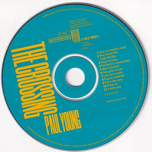 Blue CD with yellow text: "The Crossing" by Paul Young, tracklist visible.