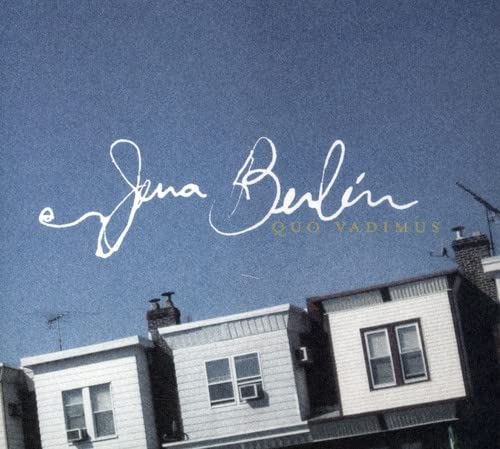 CD cover with handwritten band name against a blue sky and rooftops.