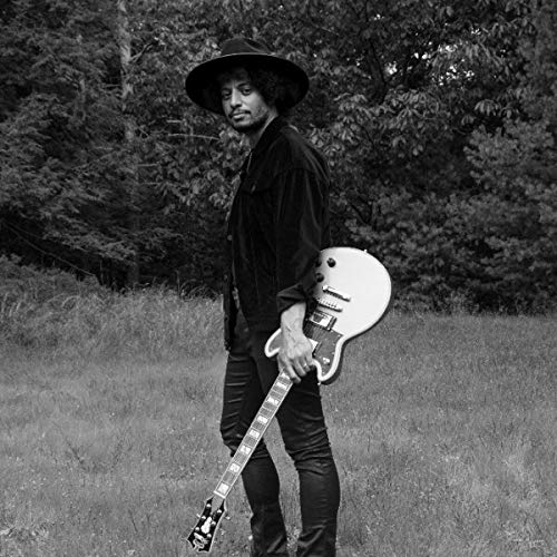Black and white portrait of a musician with a guitar.