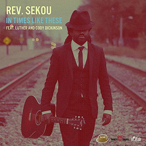 CD cover for Rev. Sekou’s “In Times Like These” featuring a man with a guitar.