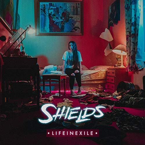 Album cover: woman sitting in a cluttered, dimly lit bedroom.