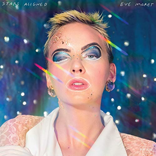 Close-up portrait of a woman with colorful makeup and glitter details.