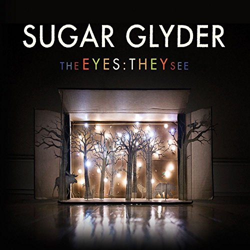 CD cover for “The Eyes They See” featuring a miniature illuminated forest.