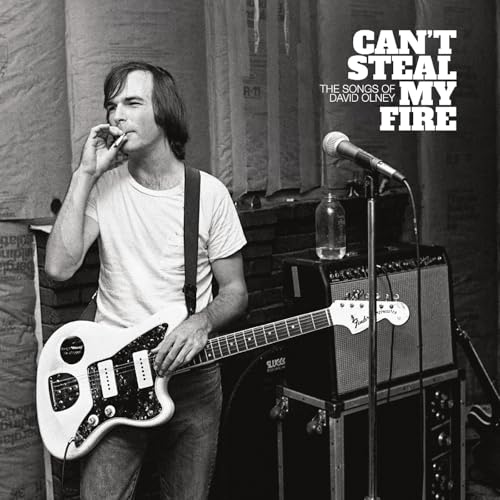 Black and white album cover featuring a musician with a guitar and microphone.