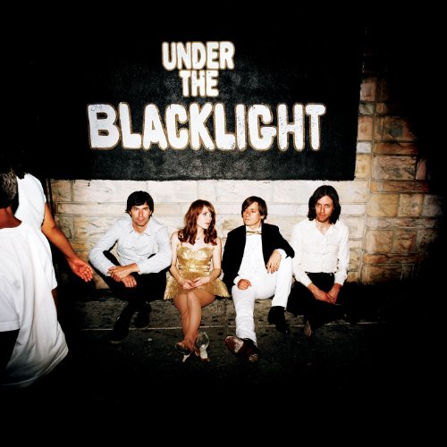 Rilo Kiley album cover: band seated before brick wall with text.