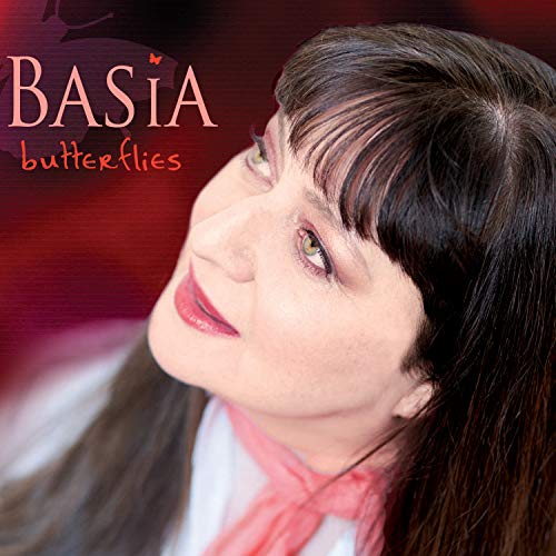 Basia album cover: portrait of a woman with dark hair and butterflies.