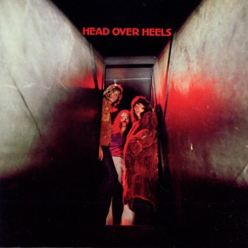 CD cover: three people stand in a dark, tunnel-like space.