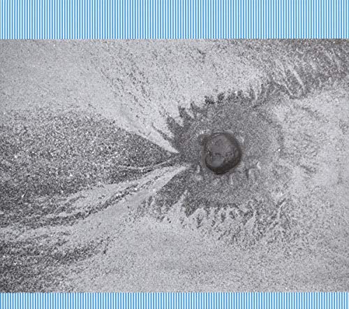 Black and white abstract image with a central dark stone or object.