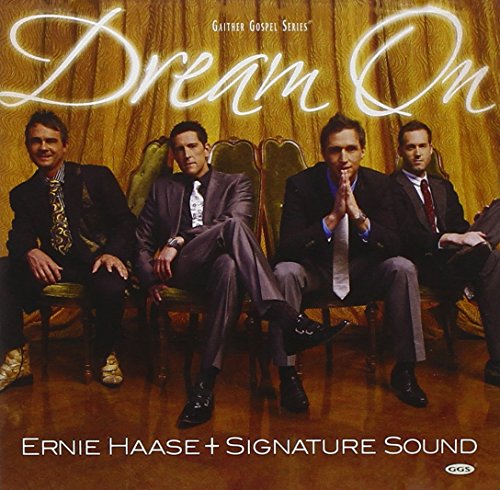 CD cover featuring four men in suits seated against a gold curtain.