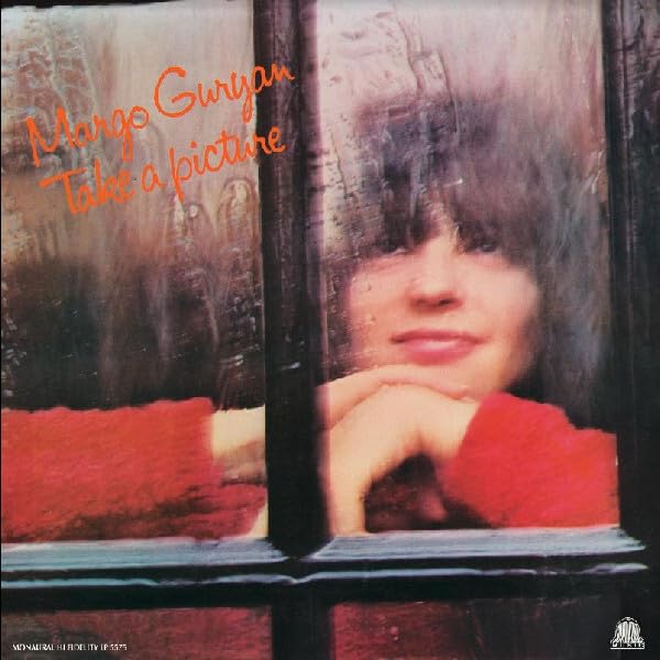 Record cover: woman looking through a window, red text, brown vinyl.