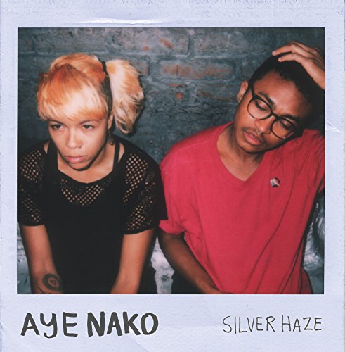 Square album cover featuring two people against a brick wall.