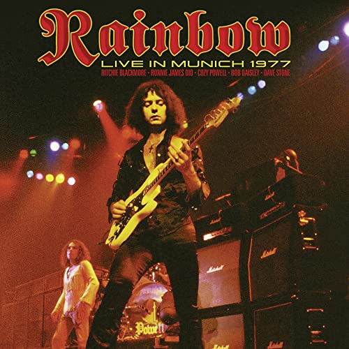 Rainbow band performing live on stage with guitars and amplifiers.