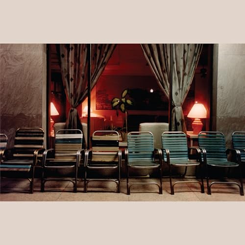 Vinyl record cover featuring a warmly lit room with chairs and curtains.
