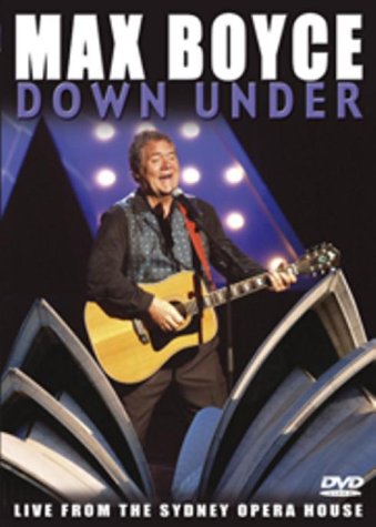 Max Boyce playing guitar on stage at the Sydney Opera House.