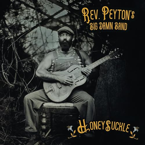 Man with guitar seated outdoors, album cover for Reverend Peyton’s Big Damn Band.