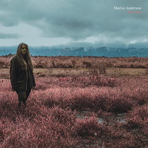 CD cover: Woman standing in a pink, marshy landscape under cloudy skies.