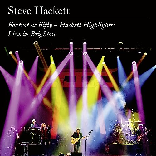 Steve Hackett live band performing on stage with bright spotlights.