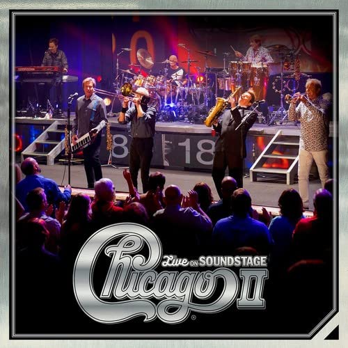 Chicago band performing live on stage with audience, album cover art.