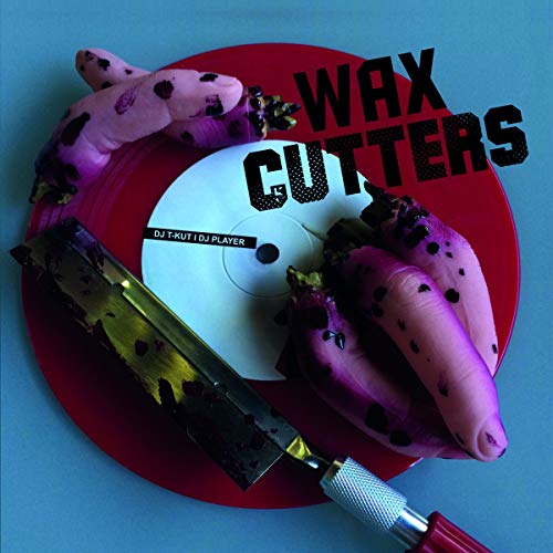 Red vinyl record with dragon fruit and a knife on top.