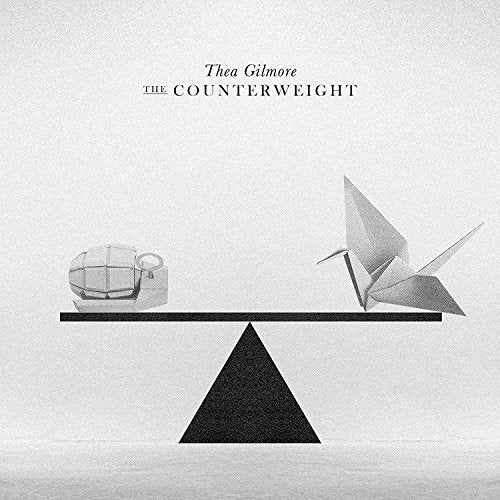Album cover: grayscale image of a balance scale with origami figures.