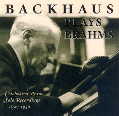 Black and white photo of Wilhelm Backhaus playing a grand piano.