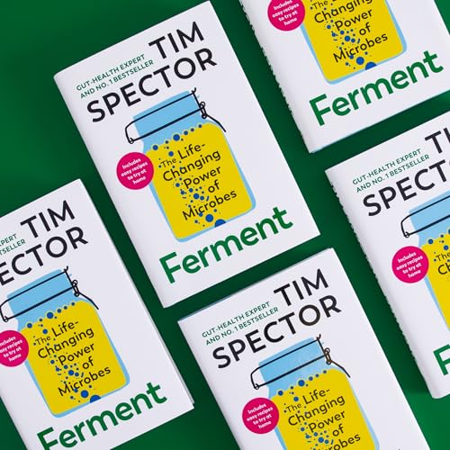Overhead view of four copies of Tim Spector’s book, “Ferment,” with green accents.