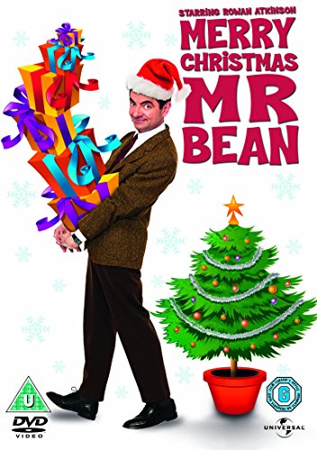 Mr. Bean in a Santa hat with a stack of Christmas gifts and a tree.