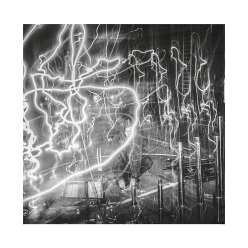 Black and white album cover with abstract light trails and a figure.