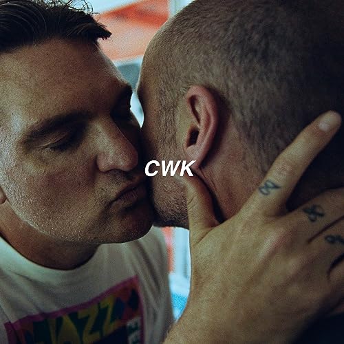 Two men in close proximity with the letters CWK centered between them.