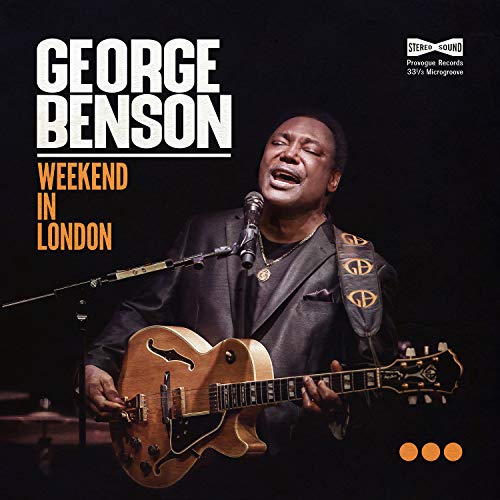 George Benson playing guitar and singing on album cover, dark background.