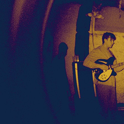 CD cover with a shadowy figure and a man playing guitar.