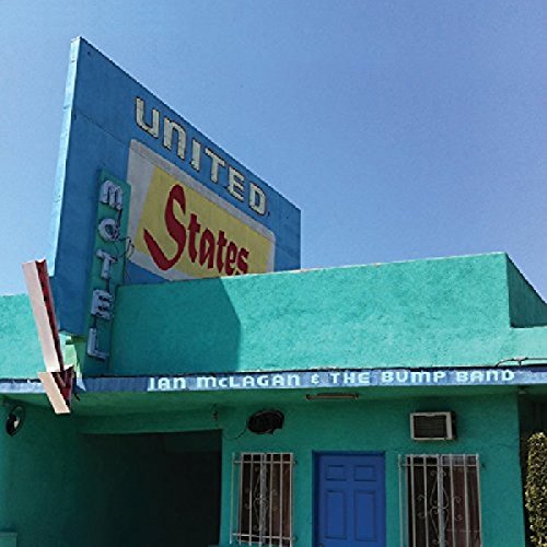 Turquoise motel building with "United States" sign, album cover art.