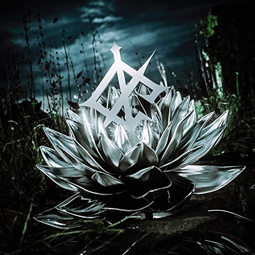 Silver floral sculpture against a dark, stormy, overgrown background.