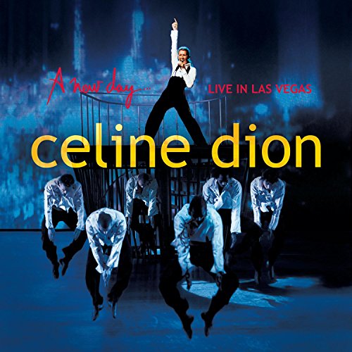 Celine Dion album cover: singer with dancers, blue background, gold text.