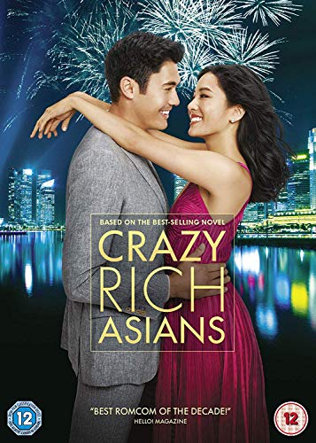 A man and woman embrace against a backdrop of city lights and fireworks.