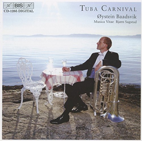 CD cover: man with tuba, table, and chairs by the sea.