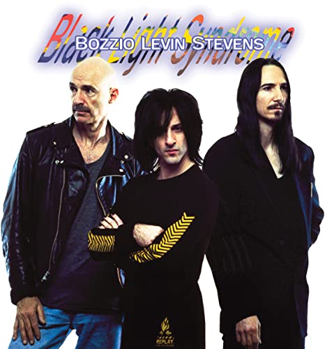 Album cover for Bozzio Levin Stevens’ “Black Light Syndrome” featuring three musicians.