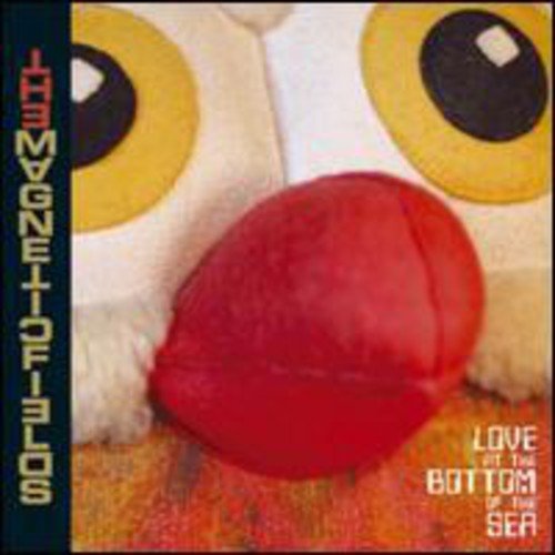 CD cover with large yellow eyes, a red object, and text.