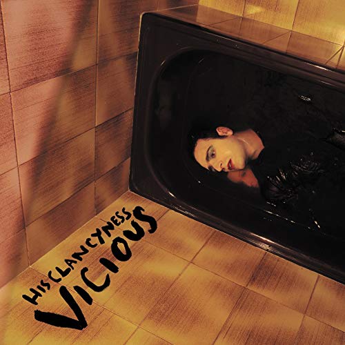 Person submerged in dark water within a tiled bathroom; album cover.
