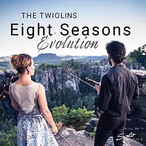 Two violinists with instruments, overlooking a mountainous landscape.