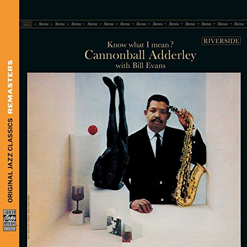 Album cover: Cannonball Adderley with sculpture, holding a saxophone.