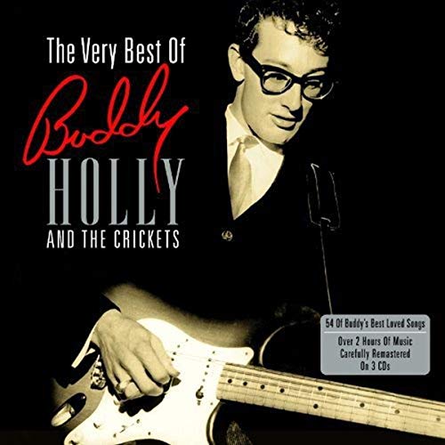 Black and white photo of Buddy Holly wearing glasses and playing an electric guitar.