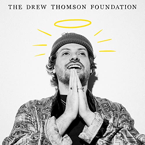 Black and white portrait of a man with hands pressed in prayer.