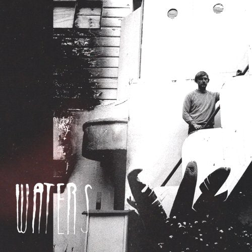 Black and white album cover with a man leaning out of a doorway.