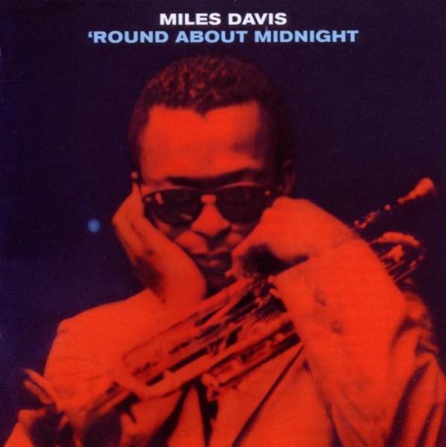 Miles Davis with saxophone, album cover in red and blue tones.