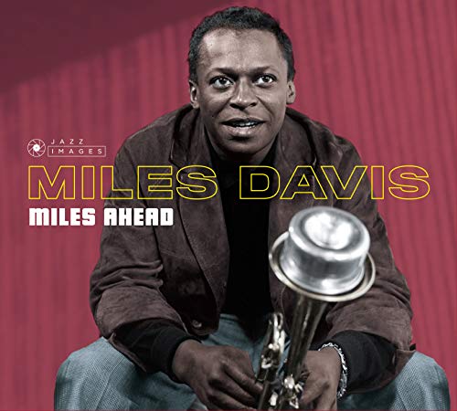 Miles Davis holding a trumpet, album cover with red background.