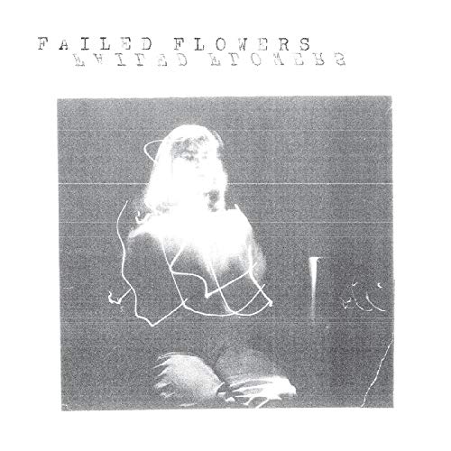 Black and white vinyl record cover with a blurred seated figure.