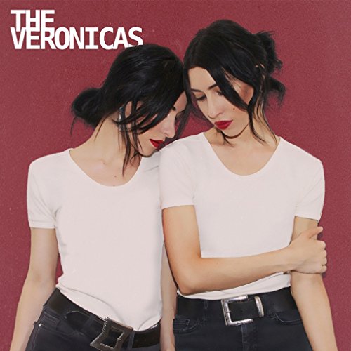 The Veronicas album cover featuring two women with dark hair on a red background.
