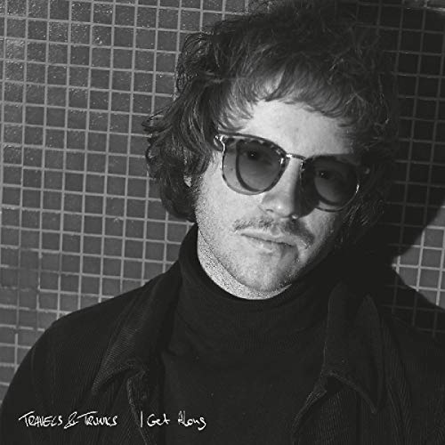 Black and white portrait of a man wearing sunglasses, album cover.