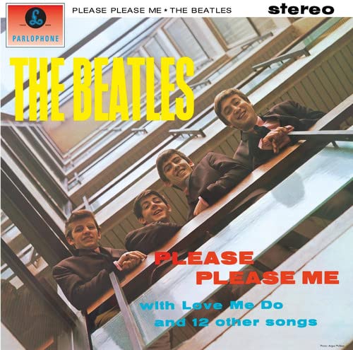 The Beatles looking down over a balcony railing on the Please Please Me album cover.